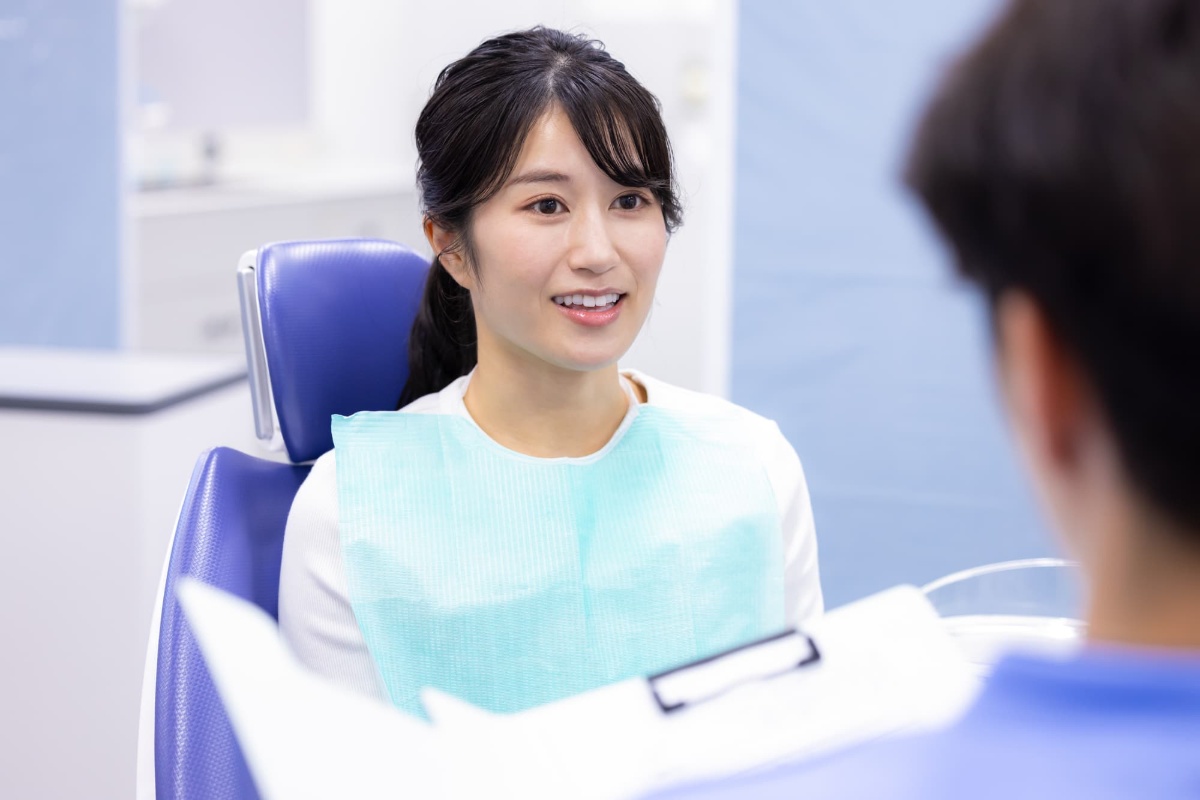 後戻りがおこって歯科医に相談している女性